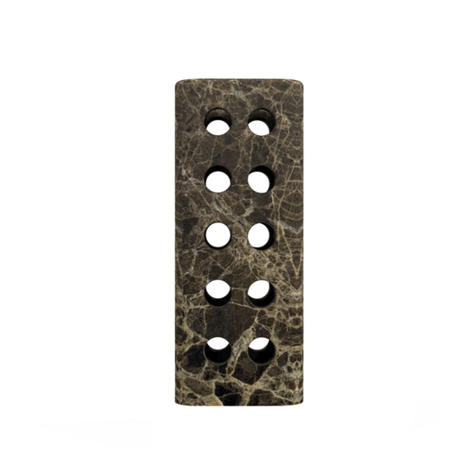 The Geo Marble Vase by Greg Natale is a rectangular dark marbled stone decor piece with eight circular holes in two vertical columns, displayed on a white background.