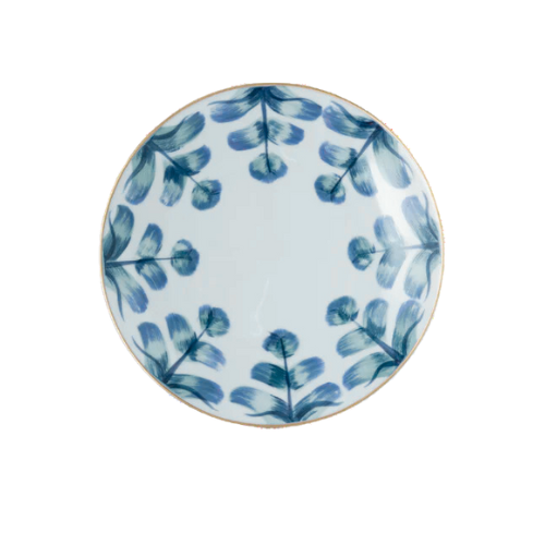 The Marie Daage Marqueyssac 1 by Marie Daâge is a round ceramic plate featuring a white background with symmetrically arranged blue brushstroke leaf patterns, inspired by classic hand-painted tableware.