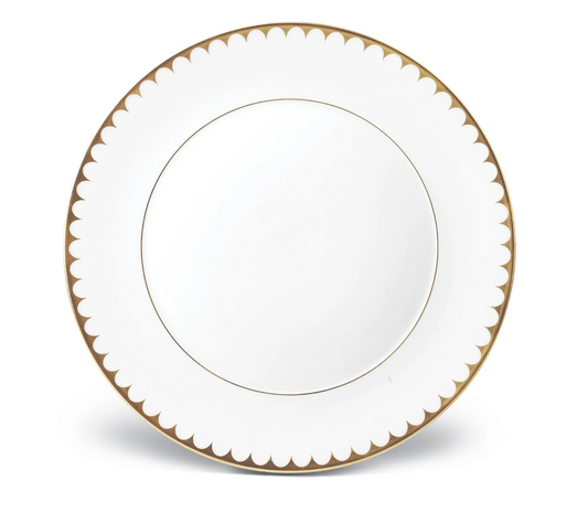 The L'Objet Aegean Filet Gold Dinnerware plate is crafted from fine white porcelain with a gold scalloped border and a thin 24k gold inner ring, set against a classic white background.