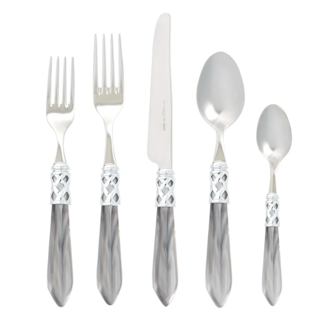 Aladdin flatware with light grey handles.