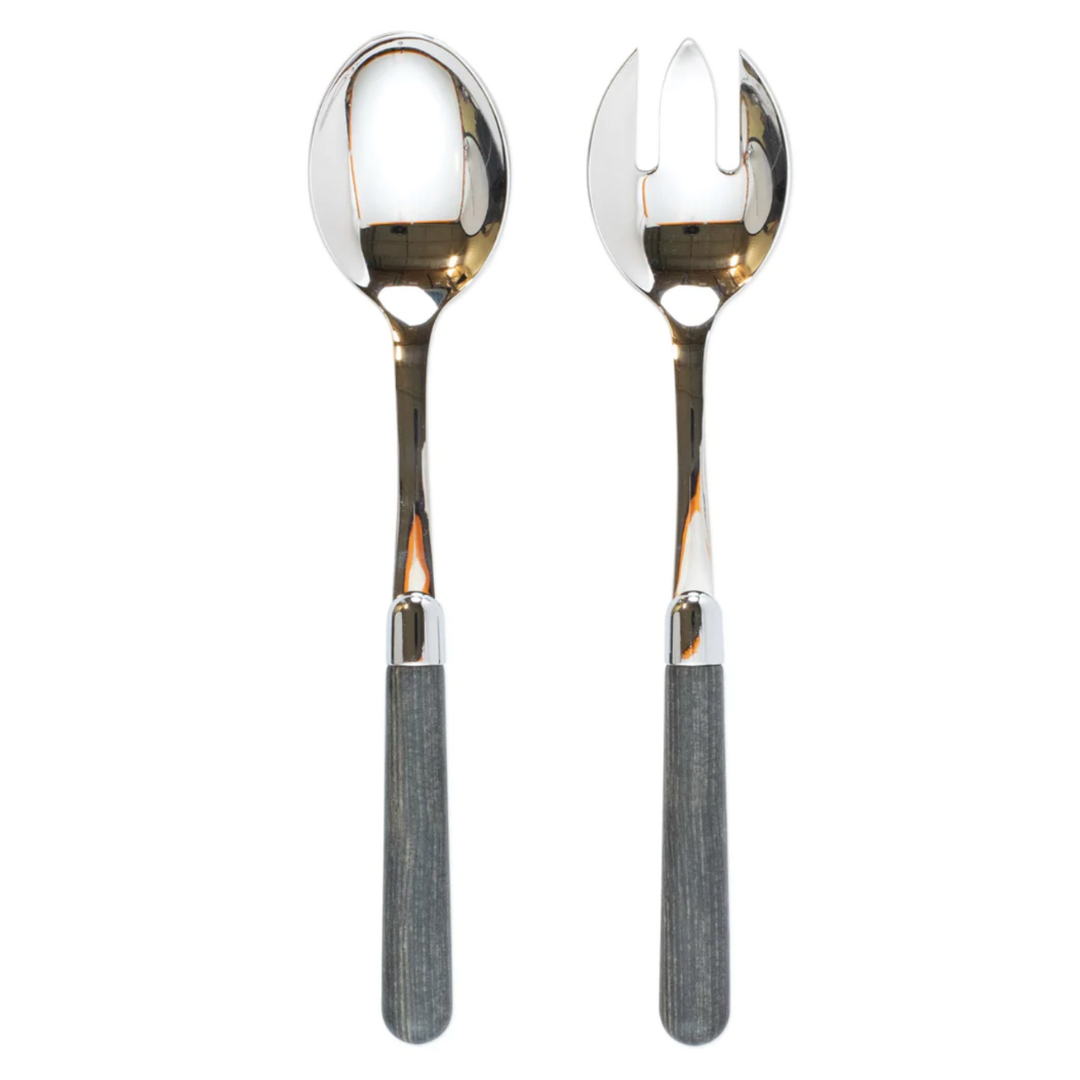 This salad server set is made of stainless steel and features acylic grey wood handles.