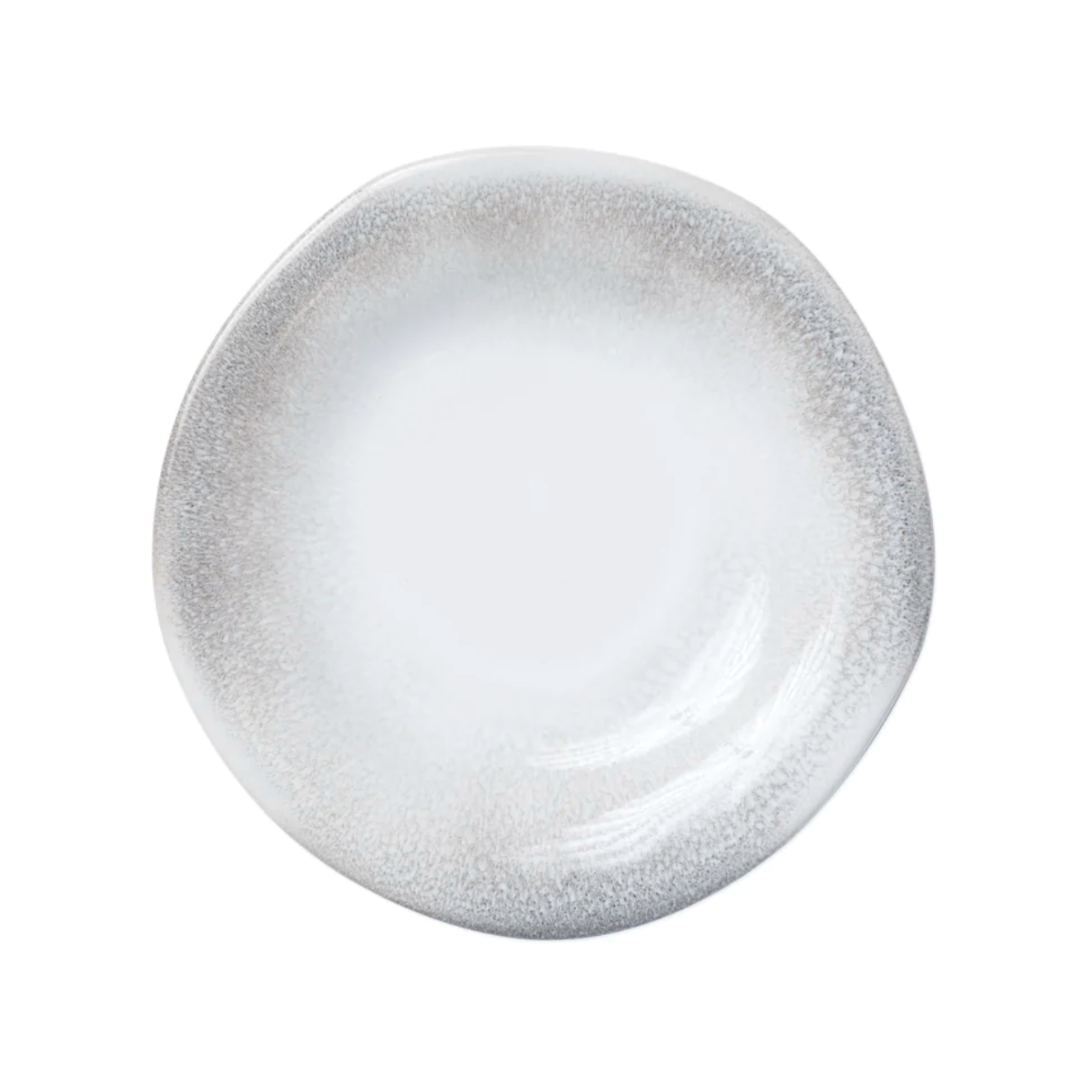 This salad plate is made of stoneware and has an ash-like design along the ridges.