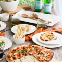 Displayed with various foods, the lastra collection features a unique stoneware design.