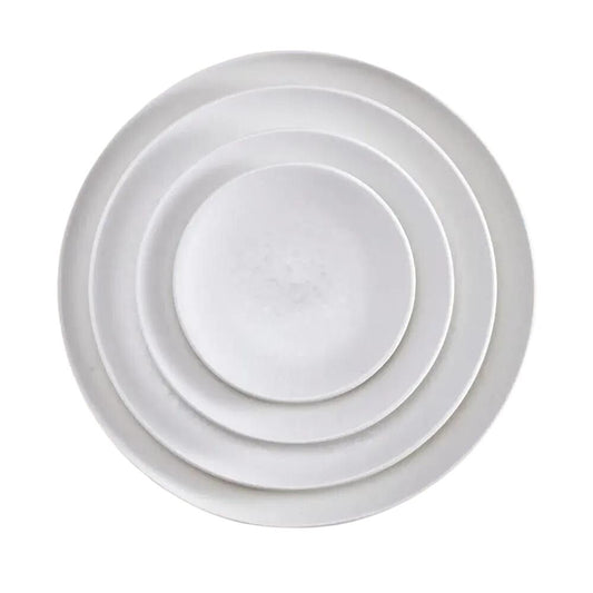 Four white, round Alchimie Dinnerware plates by L'Objet are stacked neatly inside one another, viewed from above on a plain white background—luxurious tableware ideal for any refined setting.