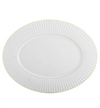 The 200 Anos Dinnerware by Vista Alegre is an oval white porcelain plate with a fluted textured rim and hand-painted gold trim—ideal for adding modern elegance to any luxurious dinnerware set.