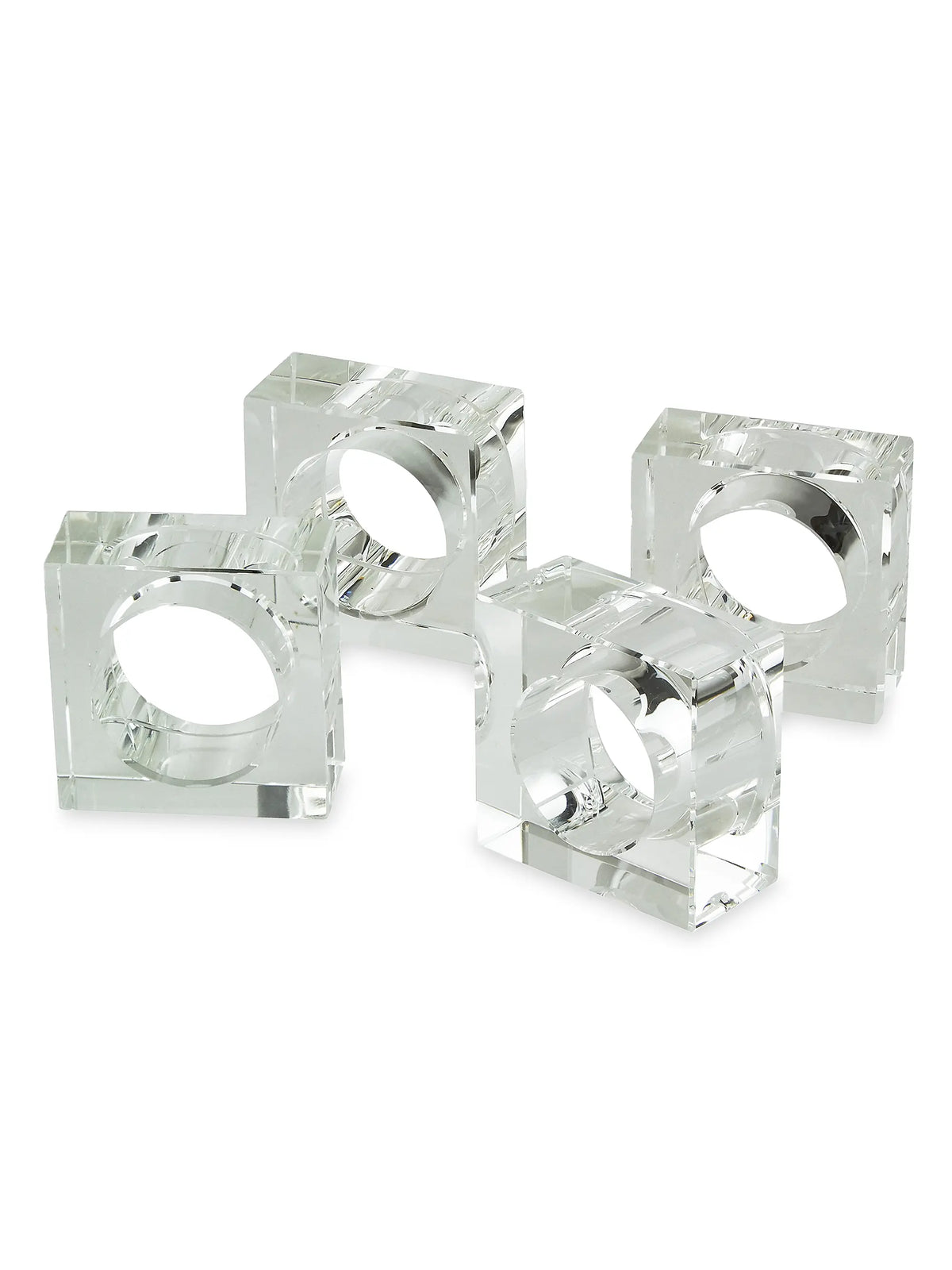 The Tizo Crystal Cube Napkin Ring Set of 4 features clear, rectangular acrylic napkin rings arranged together on a white background. Each modern table accessory has a circular opening in the center for holding napkins, reminiscent of crystal napkin rings. Their acrylic construction beautifully reflects light, enhancing the sleek and contemporary look.