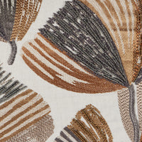 The Moonflower Pillow 16 x 24 by Threads Soft Goods features large abstract leaf patterns in brown, beige, and gray with intricate beadwork and textured stitching on light fabric.