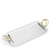The Ring Rectangle Serving Tray by Anna New York is a high-shine rectangular silver serving tray featuring rounded corners and two large oval gold handles on each end. Displayed empty against a plain white background, this decorative tray adds a touch of elegance to any setting.