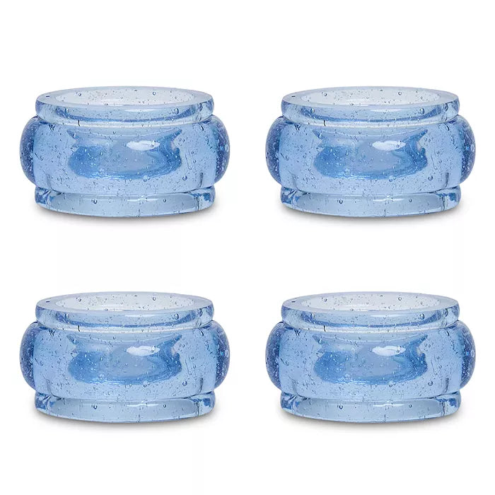 Four round blue glass Provence Napkin Ring Set/4 with a bubbled texture, perfect for colorful table decor.