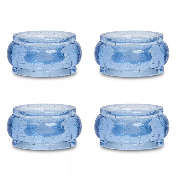 Four round blue glass Provence Napkin Ring Set/4 with a bubbled texture, perfect for colorful table decor.