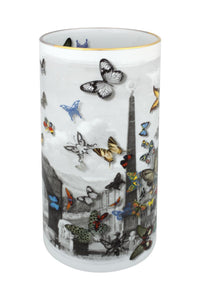 The Large Forum Vase by Christian Lacroix for Vista Alegre is a cylindrical porcelain piece adorned with a striking black-and-white cityscape, accented by colorful butterflies of varying sizes fluttering across its surface. This artistic vase seamlessly blends modern design with timeless elegance, capturing the distinctive style of Christian Lacroix.