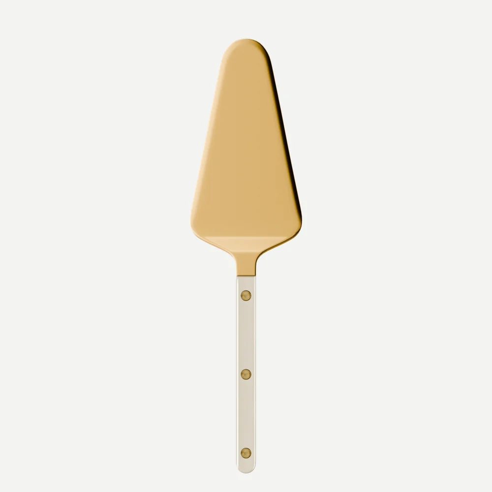 The Sabre Bistro Pearly Gold - Tart Server features a golden, triangular blade and a handle adorned with three small round rivets, drawing inspiration from classic French bistro style. It is displayed against a plain white background.