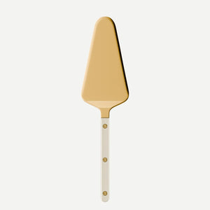 The Sabre Bistro Pearly Gold - Tart Server features a golden, triangular blade and a handle adorned with three small round rivets, drawing inspiration from classic French bistro style. It is displayed against a plain white background.