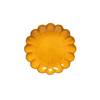 A Marrakesh Dinnerware Yellow plate by Casafina/Costa Nova, crafted from eco-stoneware with flower-like scalloped edges, is elegantly centered on a white background.