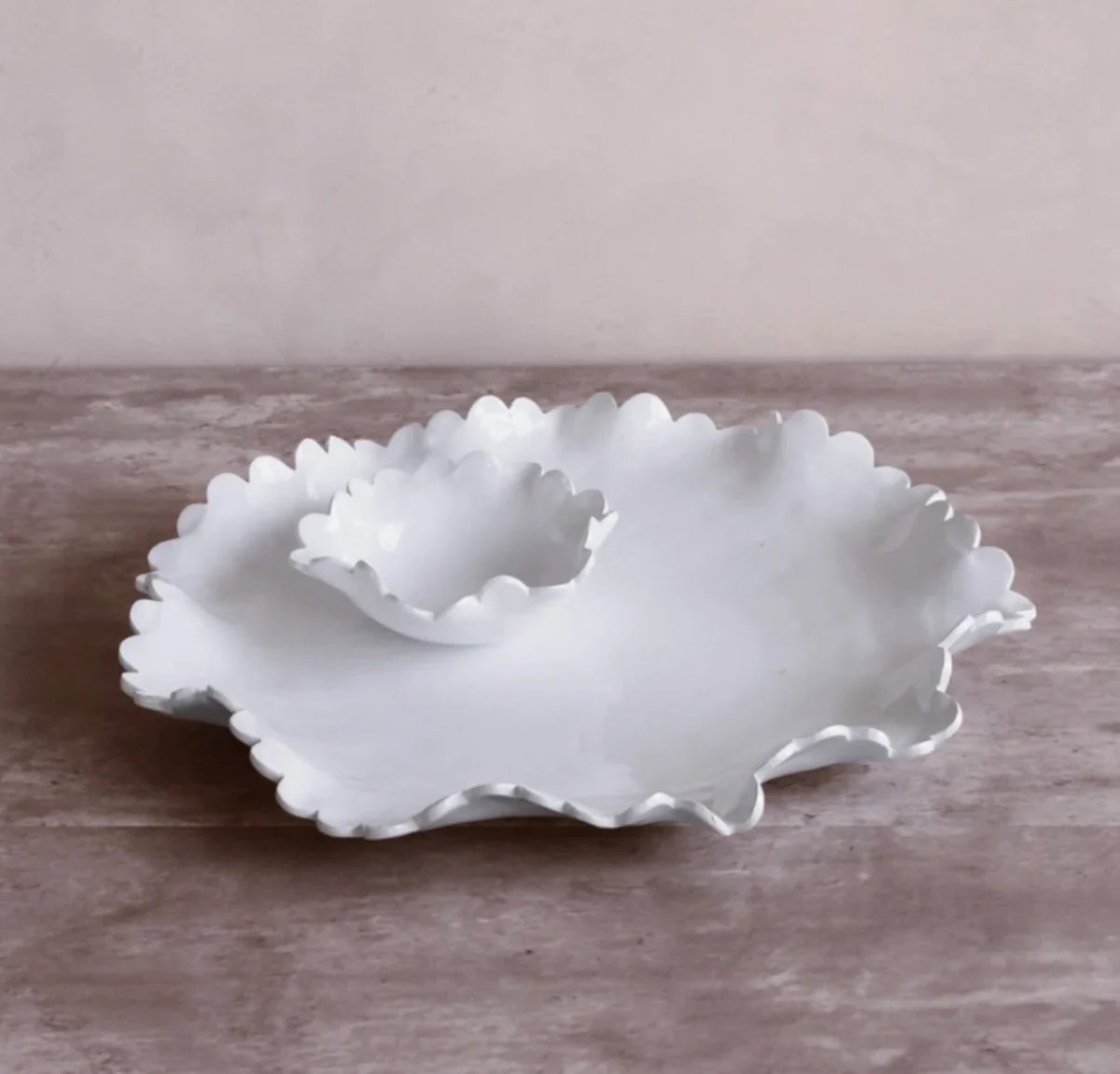 The Beatriz Ball Vida Colette Melamine Round Platter with Mini Dip Bowl in white sits on a light wood surface, offering an elegant and durable serveware option for outdoor entertaining.