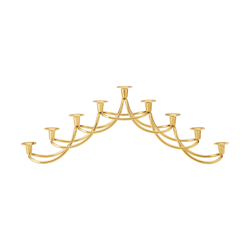 The Georg Jensen Harmony Menorah features ten candle sockets in a symmetrical, arching 18kt gold-plated design—ideal for elegantly displaying Hanukkah candles.