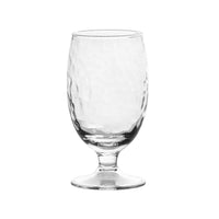 A clear, textured goblet from the Juliska Puro Glassware collection displayed on a white background. Dishwasher safe for easy cleaning.