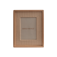 The Terreno Leather & Walnut Frame by Greg Natale features a rectangular design with a textured beige inner border, ideal for modern interiors, and displays the Greg Natale name at the center on a plain background.