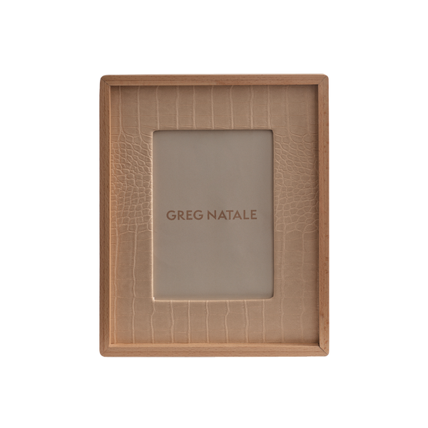 The Terreno Leather & Walnut Frame by Greg Natale features a rectangular design with a textured beige inner border, ideal for modern interiors, and displays the Greg Natale name at the center on a plain background.