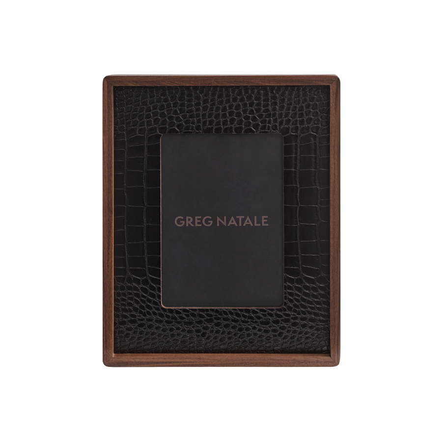 The Terreno Leather & Walnut Frame by Greg Natale features a dark walnut border and a black crocodile-patterned vegan leather inner section. A gold-lettered GREG NATALE placeholder card adds style to modern interior decor.
