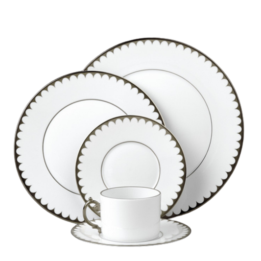 L'Objet's Aegean Filet Platinum Dinnerware set features white porcelain with scalloped dark borders and includes a dinner plate, salad plate, bread plate, teacup, and saucer—all in a matching, refined design.