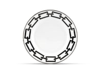 Experience modern elegance with the Ginori 1735 Catene Nero Dinnerware. This white ceramic plate showcases a striking black geometric pattern of interlocking rectangles along the rim, creating a contemporary and stylish border. The center remains plain and unadorned for a refined finish.