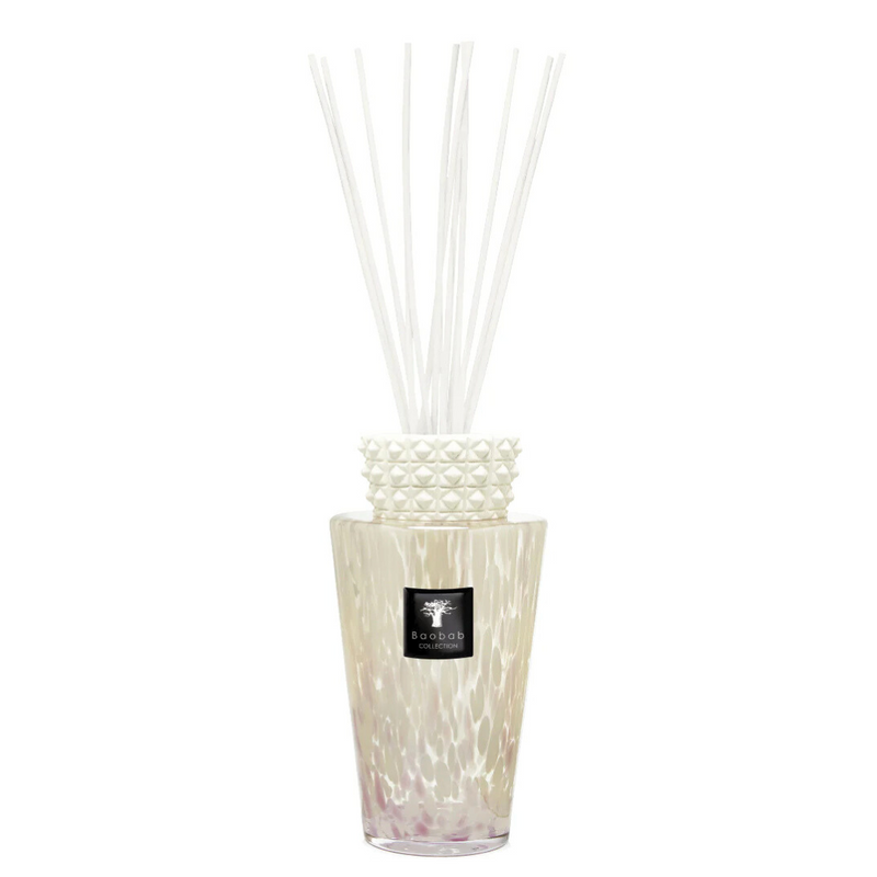 The Totem Pearls White Diffuser by Baobab features a decorative glass design with a textured white collar, filled with liquid and white reeds—an elegant touch to enhance your home fragrance experience.