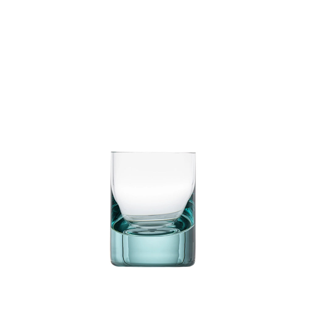 A Moser Whiskey Set Shot Glass with a thick, teal-tinted base—evoking classic Moser colours—stands centered on a plain white background.