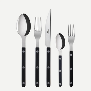 The Sabre Bistrot Solid Flatware 5 Piece Setting - Shiny includes a tablespoon, dinner fork, knife, teaspoon, and salad fork with black handles, shown upright on a white background. Paris-inspired design from the Bistrot collection.