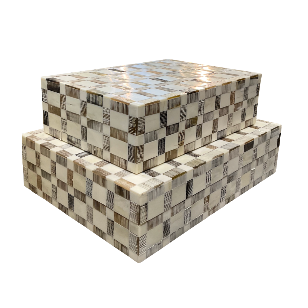 Two rectangular Etched Cavern Bone Box - by A Sanoma Inc, stacked together with a checkered beige, cream, and brown pattern and subtle hand-etched detailing, set against a white background.