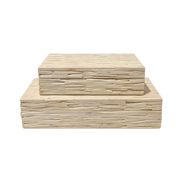 Two rectangular Bone Tiles Boxes in ivory, from A Sanoma Inc, display a textured, layered pattern as they are stacked—with the medium box resting atop the larger one—against a white background. Their subtle mosaic design enhances the sophisticated elegance of these decorative pieces.