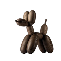 A large Balloon Dog sculpture by Boyhood - Ameico, crafted from smoked oak with smooth surfaces and visible natural grain in each segment, showcased against a plain white background.