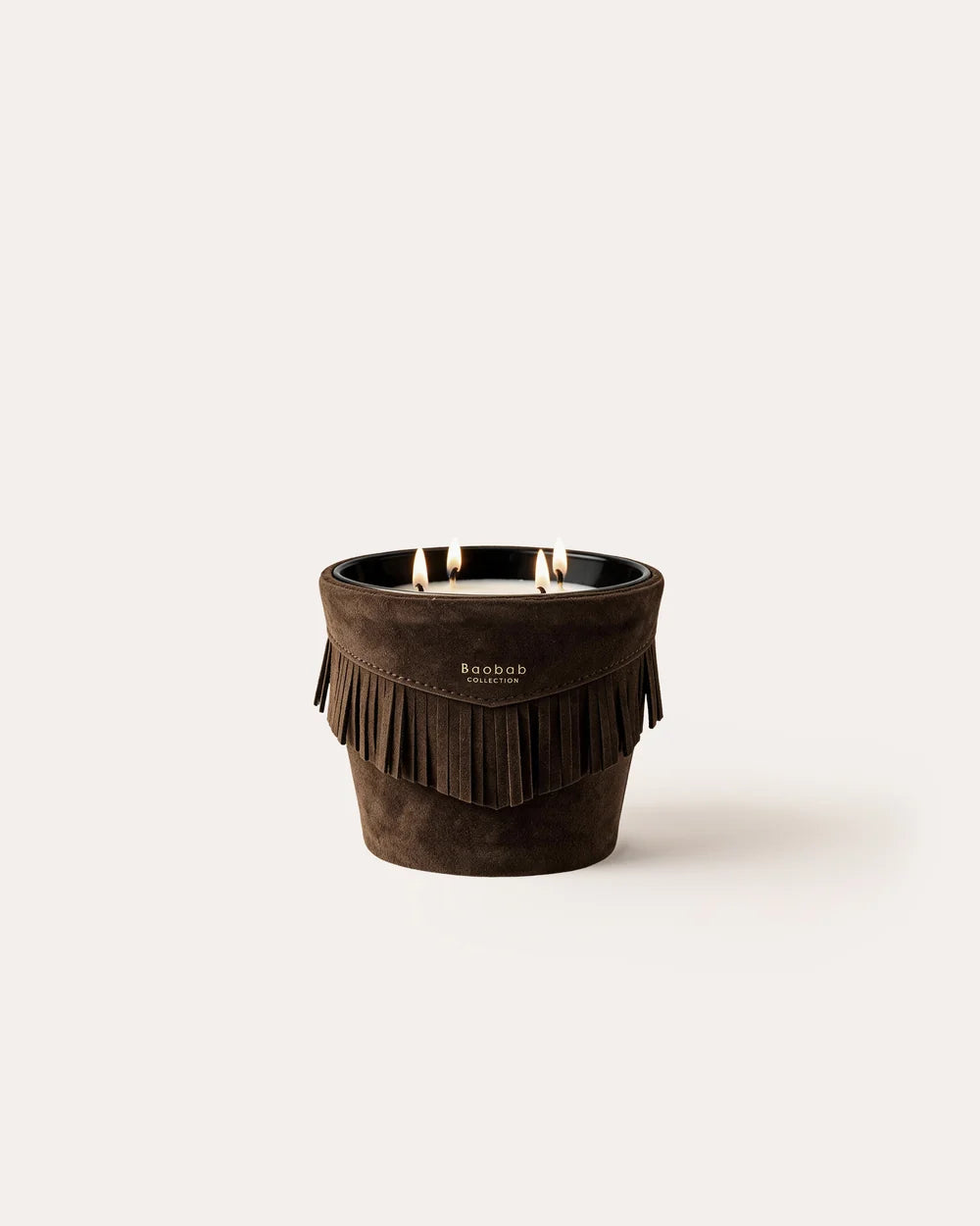 A Calamity Jane Candle - Deadwood three-wick patchouli candle in a dark brown, suede-covered holder with fringe.