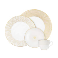 Two white porcelain plates, a saucer, and a teacup from the Christofle Malmaison Imperiale Porcelain Dinnerware Gold collection, all decorated with gold geometric patterns.