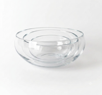 The Gary Bodker Nesting Bowl Collection Clear features three hand-blown glass bowls nested together on a plain white background.