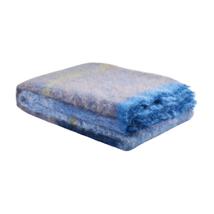 Folded Cushendale Boher Extra Large Throw in shades of blue with a fringed edge.