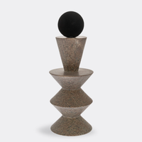 The Constantin Gray w/ Black Sculpture by Gardeco features two stacked conical forms separated by a disk, topped with a black sphere, evoking the look of a modernist totem in the style of Brâncusi and set against a plain white background.