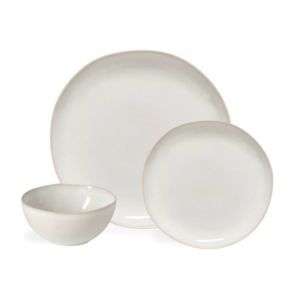 A Brisa Branca Dinnerware set by Casafina/Costa Nova, handcrafted in Portugal, includes a dinner plate, a salad plate, and a bowl—each made from stoneware with a subtle off-white glaze and slightly irregular shapes.