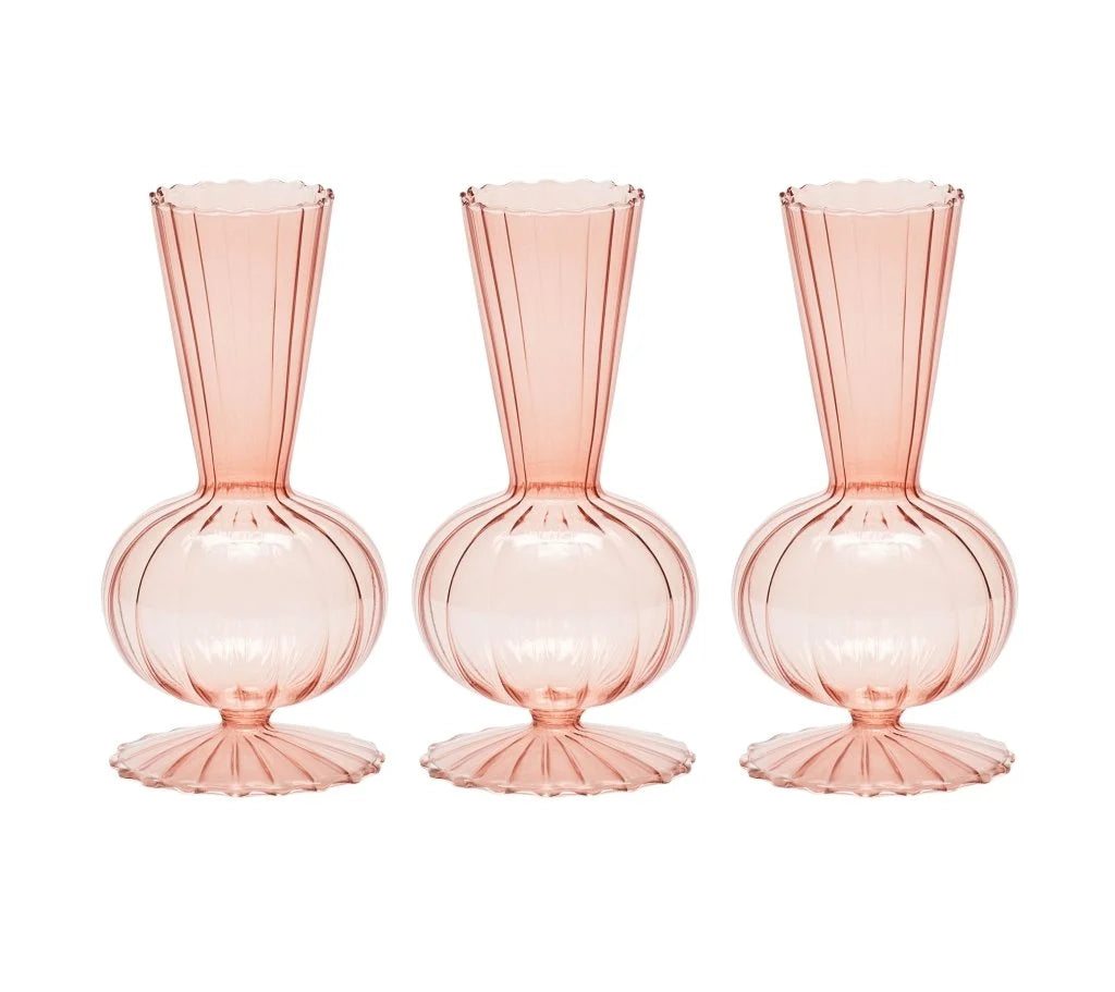 Three blush-colored Tess Bud Vase s/3 glass bud vases with bulbous bases and ribbed, flared openings.