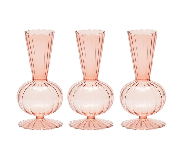Three blush-colored Tess Bud Vase s/3 glass bud vases with bulbous bases and ribbed, flared openings.
