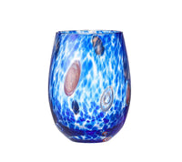 The Gala Stemless Tumbler Set of 4 by Kim Seybert features blue glass tumblers with a wavy, water-inspired pattern and multicolored circular accents—including pink, black, and clear spots—set against a white background, capturing the playful elegance reminiscent of Murano glass artistry.