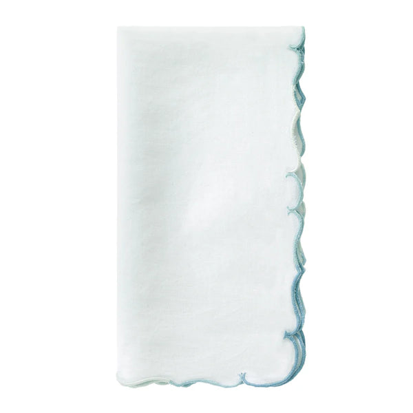 A crisp white linen napkin with scalloped edges and delicate ice blue embroidery from the Bodrum Firenze Napkin Set of 4.