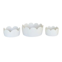 Three white, round Fleur Bowl White pieces by Tina Frey, in different sizes, are displayed side by side. Each handmade resin bowl has a smooth finish and scalloped floral edges. The background is plain white.