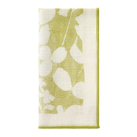 The Bodrum Fleur de Lin Napkin s/4 - Green features a folded white cotton design with green leaf and floral prints and green edging, ideal for coordinating with matching floral linens or a stylish table runner.
