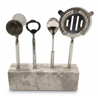 The Go Home Carpri Bartool Set 5pc includes a measuring jigger, bottle opener, mixing spoon, strainer, and marble holder—ideal for cocktail enthusiasts.