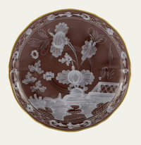 A round brown porcelain plate from the Ginori 1735 Oriente Italiano Castagna collection, adorned with white floral and fence motifs, a gold rim, and intricate border detailing, proudly Made in Italy.