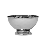 The Juliska Graham Cocktail Bowl features a shiny, hammered stainless steel construction with a slightly rounded shape, adorned with rope-like detailing around the rim and base. Its reflective surface enhances its elegant design. The bowl is empty and rests on a plain white background.