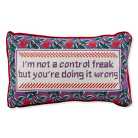 The Needlepoint Pillow - Control Freak by Furbish features a rectangular cotton velvet design with a purple, red, and green floral border. The white center reads "I’m not a control freak but you’re doing it wrong" in purple stitching.