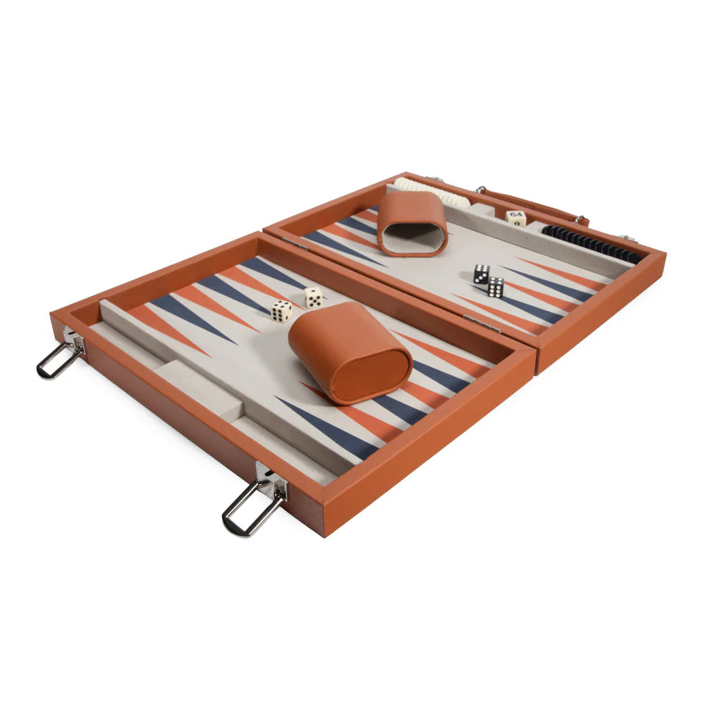 The Brouk & Co Mini Travel Backgammon Set features a brown case, an orange and blue striped board, dice, checkers, two brown dice cups, and game pieces arranged for play.