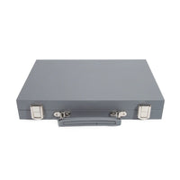 The Brouk & Co Mini Travel Backgammon Set is a closed gray metal briefcase with two silver latches and a handle, shown on a white background, designed for easy travel.